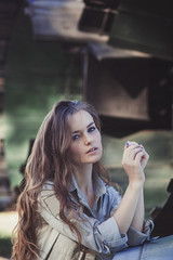 Attractive brunette woman in army uniform near airplane