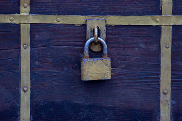  old yellow  lock on a wooden chest
