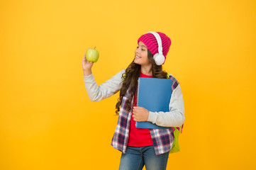 Healthy eating habits for your child. Happy girl hold apple yellow background. Enjoying healthy school snack. Healthy snacking and dieting. Offering healthy food in school. Online education