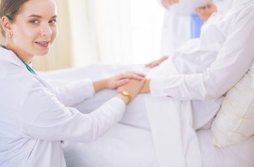 Doctors and nurses stacking hands. Isolated on white