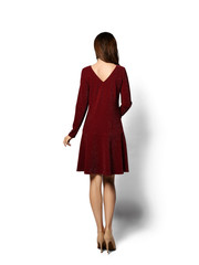 Young beautiful woman posing in new fashion long casual red cherry dress happy backside view on white 