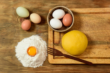Egg noodle dough bun, with ingredients on the table.