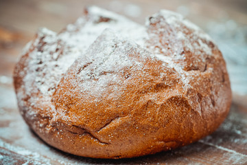 Traditional bread with a crust on a wooden board