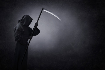 Grim reaper with scythe in the dark - obrazy, fototapety, plakaty