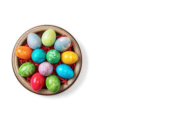 Different easter eggs in ceramic bowl isolated on white
