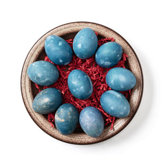 Aquamarine easter eggs in ceramic bowl isolated on white