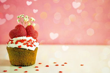 Valentines day cupcake. Cupcake with white cream and red sugar hearts on a pink background, bokeh effect, copy space. St. Valentine's Day card