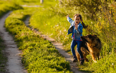 Little girl is scared by a dog.