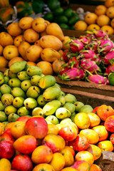 A lot of tropical fruits in outdoor market in Sri-Lanka. Colorful mango, bananas, dragon fruit