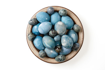 Aquamarine easter eggs in ceramic bowl isolated on white