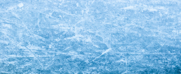 Abstract ice texture. Nature blue background. Traces of blades of skates on ice