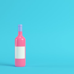 Wine bottle with blank lable on bright blue background in pastel colors. Minimalism concept
