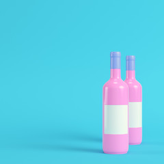 Two wine bottles with blank lables on bright blue background in pastel colors. Minimalism concept