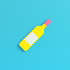 Yellow wine bottle on bright blue background in pastel colors