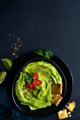 Guacamole - traditional mexican spicy avocado dip. Top view with copy space.