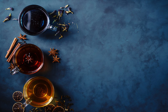 Collection of brewed green, cinnamon anise spiced and blue anchan tea in glass mugs. Tea shop and cafes