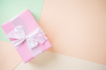 Creative holiday present. Handmade paper gift box on multicolored backdrop. Valentine's, Mother's...