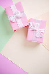 Creative background, holiday present. Handmade paper gift boxes on multicolored backdrop. Valentine's, Mother's or Women's Day. Copy space