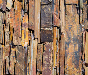 background texture-mosaic of weathered granite, quartzite and shale rock on an outdoor walkway