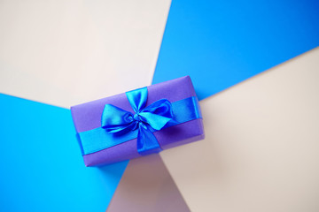 Creative background, holiday present. Handmade paper gift box on multicolored backdrop. Valentine's, Father's Day. Copy space