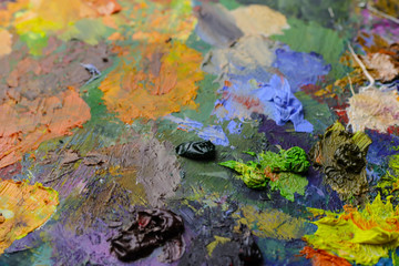 Fototapeta na wymiar Multicolor palette with bright paints, close up