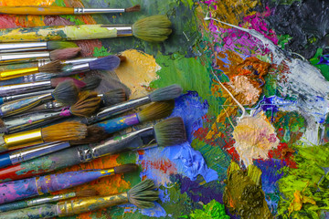Fototapeta premium Paint brushes on palette, close up