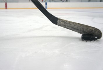 hockey stick with puck in the stadium