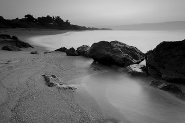 Long exposure landscape photo of rocky coast in the dawn.