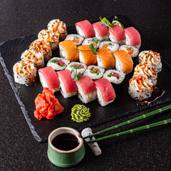fresh and tasty sushi on the black background