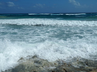 Fototapeta na wymiar Waves Crashing into Rocks on Coast of Cozumel, Mexico