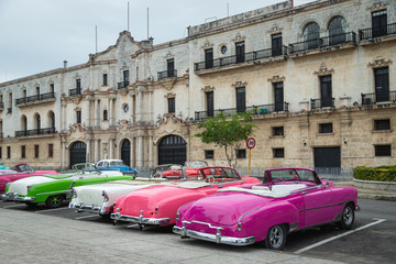 Multi-colored retro cars in the center of old Havana. City flavor