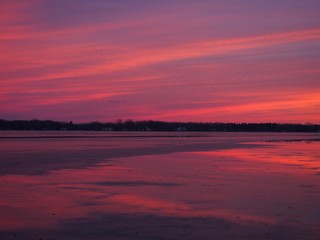 Naklejka na ściany i meble Beautiful Winter Sunset on Ice Covered Lake