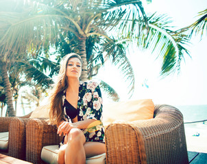 young pretty woman at swimming pool relaxing in chair, fashion look in lingerie at hotel, lifestyle...