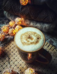 cup of coffee with beans and cinnamon sticks