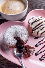 chocolate fondant with ice cream on wooden rustic background