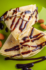 crepes with banana and chocolate spread on a green plate