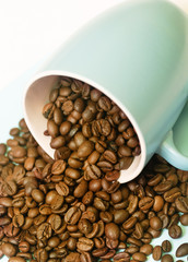 cup of coffee with beans on white background