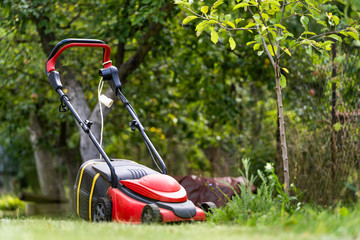 Lawn mower on green grass