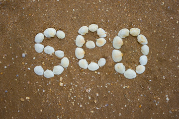 Inscription on sand from shells - seo, camping, tourism