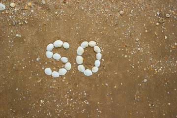 Inscription on sand from shells - so, camping, tourism