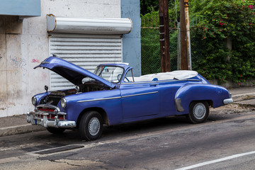 The bonnet of a purple convertible car seen up waiting for repairs in Havana, Cuba in November 2015.
