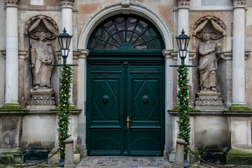 Main entrance of St. Peter's Church with statues and streetlamps, Old Riga Latvia