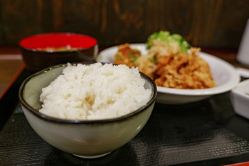 Selected focus view at rice bowl of Japanese style Deep fried Chicken menu, Tori Kara or Tori Pon, serve with miso soup and rice on side. 