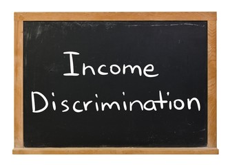 Income discrimination written in white chalk on a black chalkboard isolated on white