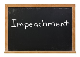 Fototapeta premium Impeachment written in white chalk on a black chalkboard isolated on white