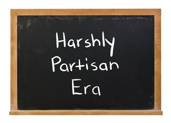 Obraz premium Harshly partisan era written in white chalk on a black chalkboard isolated on white