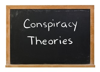 Obraz premium Conspiracy theories written in white chalk on a black chalkboard isolated on white
