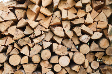 Stacks of firewood in the sawmill. Pile of firewood. Firewood background
