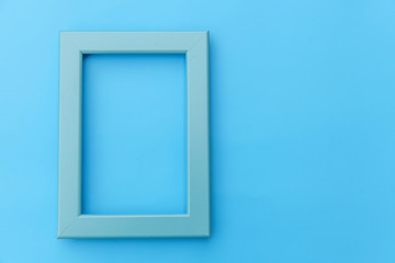 Simply design with empty blue frame isolated on blue pastel colorful background. Top view, flat lay, copy space, mock up. Minimal concept