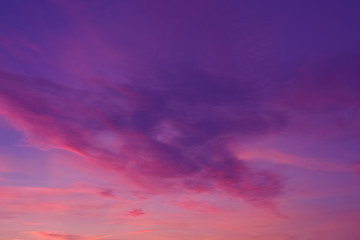 Colorful clouds in summer evening sky. Bright and pink clouds in sky sunset or sunrise. Beautiful purple pink evening sky background.